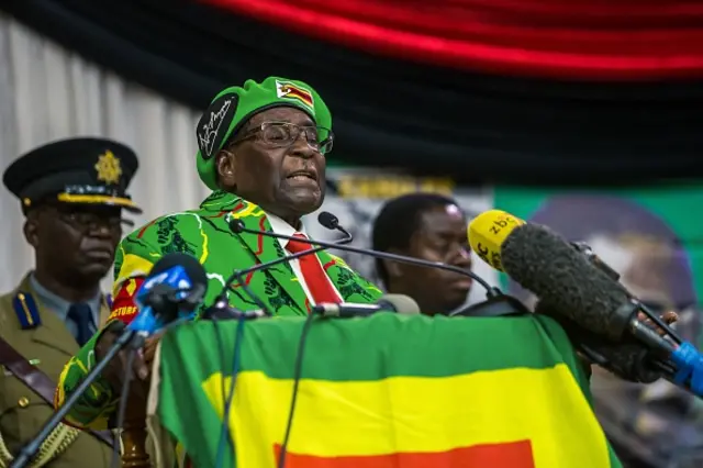 Zimbabwe's President Robert Mugabe delivers a speech during a meeting of his party's youth league where he hinted at a cabinet reshuffle, on October 7, 2017, in Harare