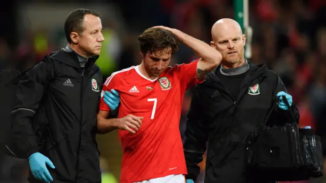 Joe Allen holding his head
