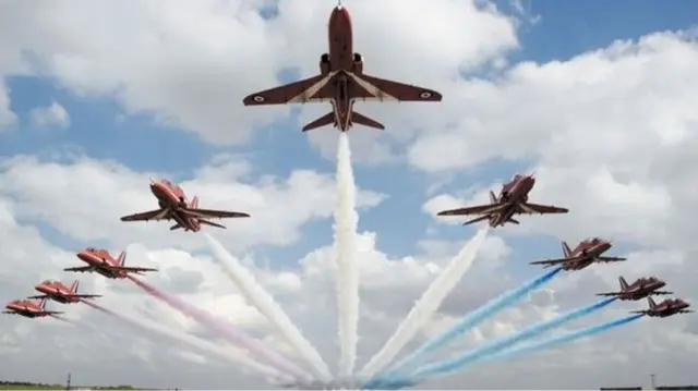 Red Arrows jets flying in formation.