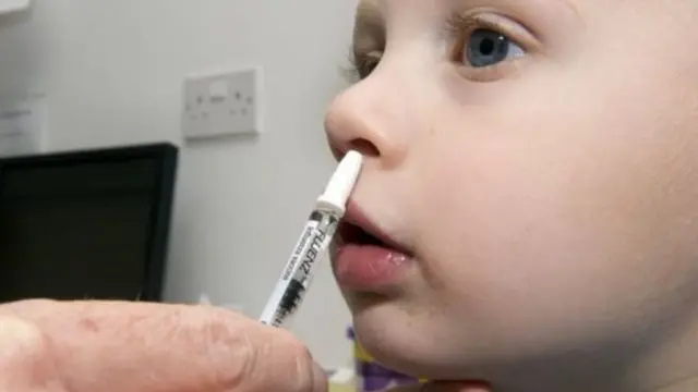 Child having nasal vaccine.