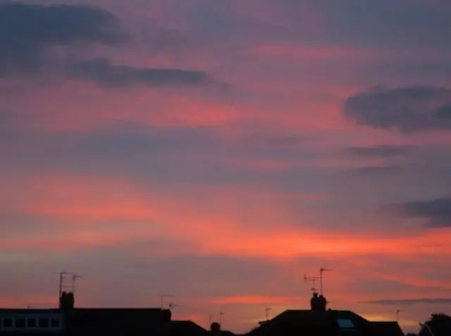 Red skies above rooftops.