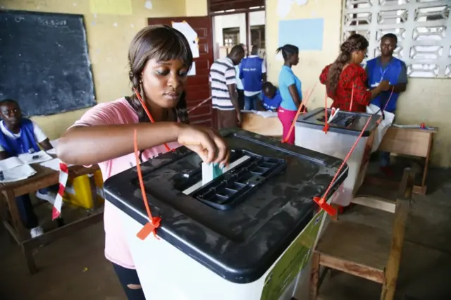 A Liberian woman casts her ballot to vote in presidential and general elections in West Point, Monrovia, Liberia, 10 October 2017