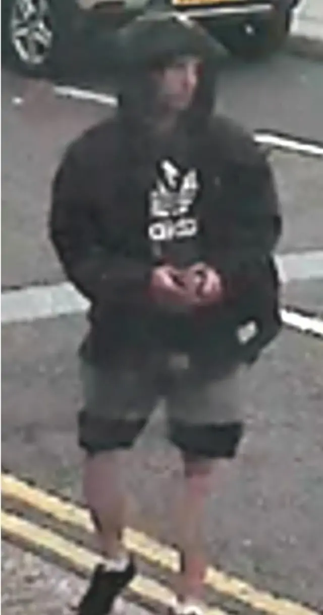 Suspect wearing a hoodie and long shorts.