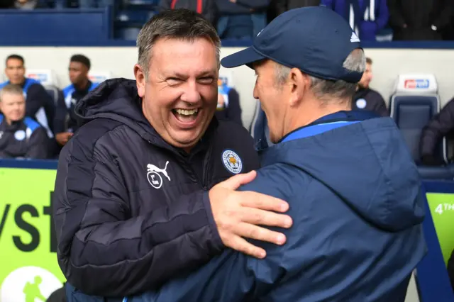 Leicester manager Craig Shakespeare embraces West Brom boss Tony Pulis (right)