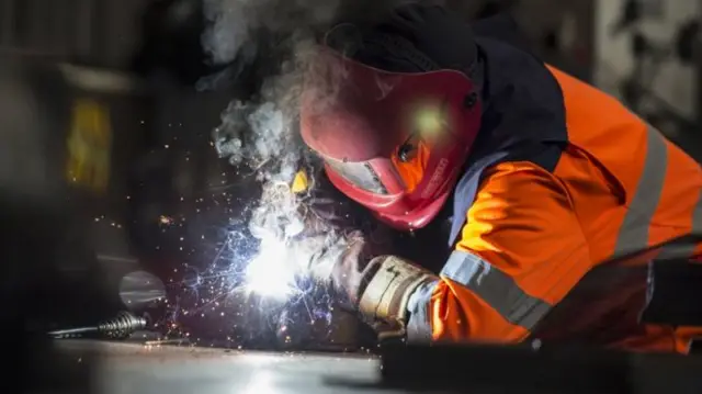 A steel worker welding