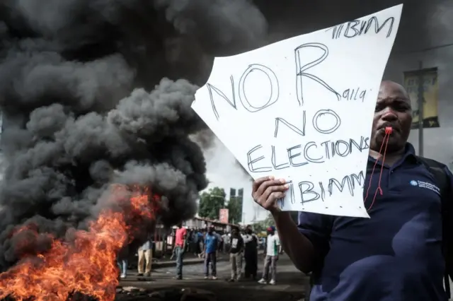 An opposition supporter holds a placard during their protest against Independent Electoral and Boundaries Commission (IEBC) officials over claims of bungling the August presidential vote, which was nullified by the Supreme Court, in Kisumu, Kenya, on October 11, 2017