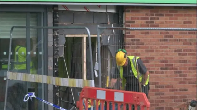 Workers at the Co-Op store in Broughton fixing a big hole in the wall.