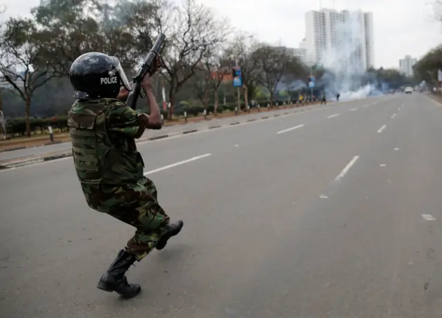 A riot policeman fires tear gas to disperse supporters of Kenyan opposition National Super Alliance