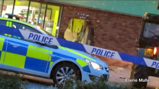 Hole in wall and a police car.