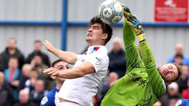 Linfield's Jimmy Callacher in action against Chris Johns of Coleraine