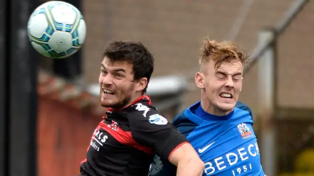 Philip Lowry of Crusaders in an aerial battle with Glenavon's Mark Sykes at Seaview