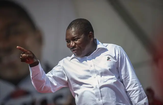 Filipe Nyusi addresses a cheering crowd of supporters during the FRELIMO final presidential and legislative campaign rally on October 12, 2014 on the outskirts of Maputo