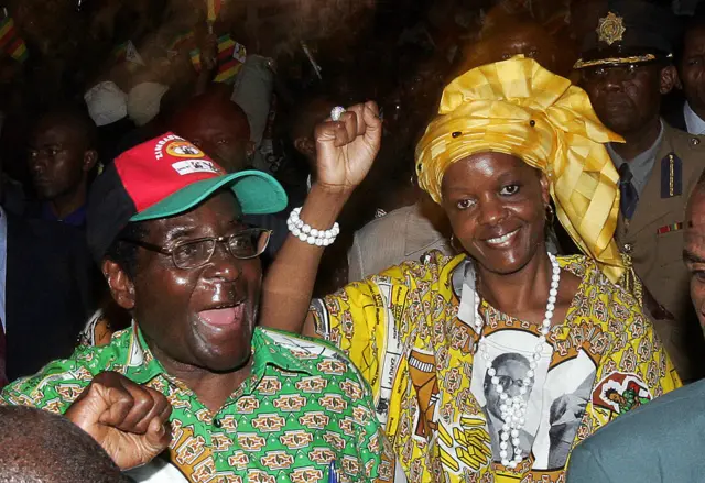 Zimbabwe's President Robert Mugabe and his wife Grace greet delegates attending the ZANU-PF party's extraodinary congress in Harare, 13 December 2007