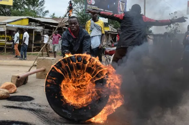 Supporters of opposition coalition the National Super Alliance (NASA) set a tire in fire in Kisumu, western Kenya, on October 13, 2017