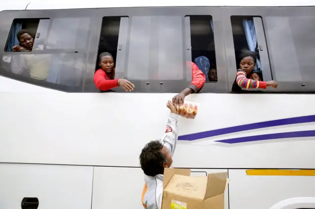 bread being passed to bus