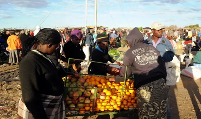 Zimbabwean women shop for vegetables in Jambanja market in Seke, 58km south of Harare, on August 2, 2013.