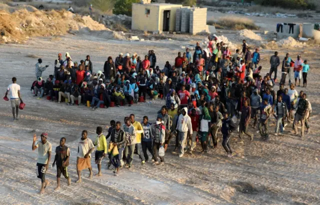 Migrants wait to receive food at a detention centre in the coastal city of Sabratha, Libya, October 9, 2017