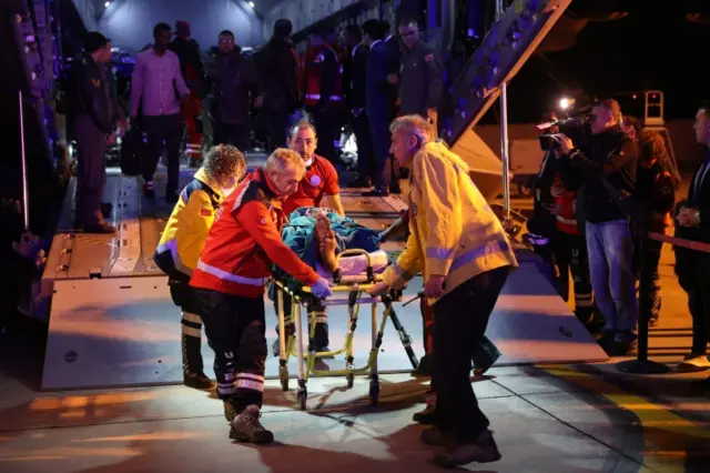 A wounded man from the latest explosion in Mogadishu is carried on a stretcher to receive treatment in a Turkish hospital