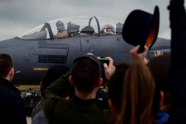 Families wave at crew in plane