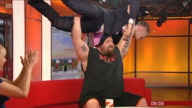 Dan Walker being bench pressed by Eddie Hall