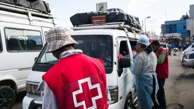 Medics inspect a bus in Madagascar