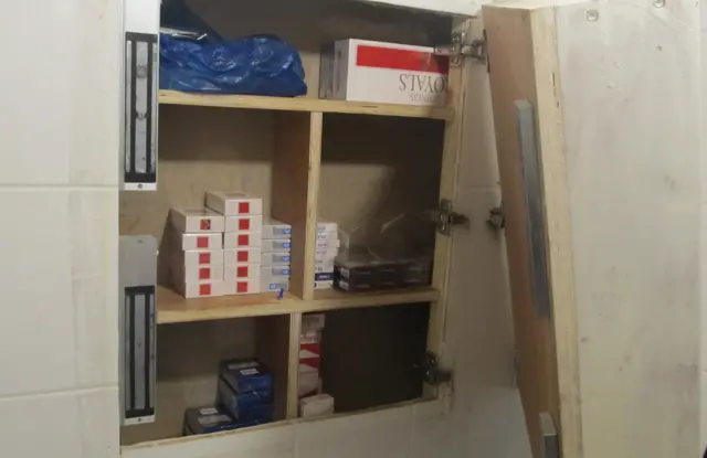 Cigarettes hidden behind cupboard