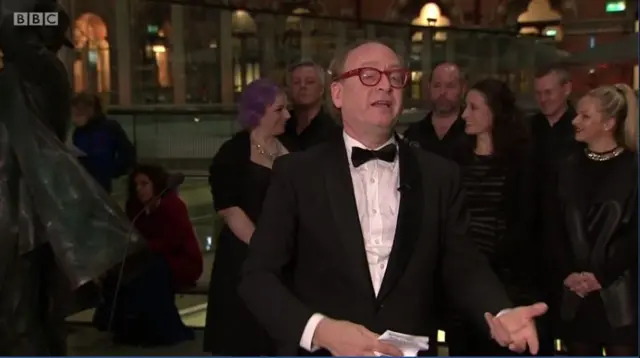 William Spaulding leads commuters in a chorus of Va Pensiero