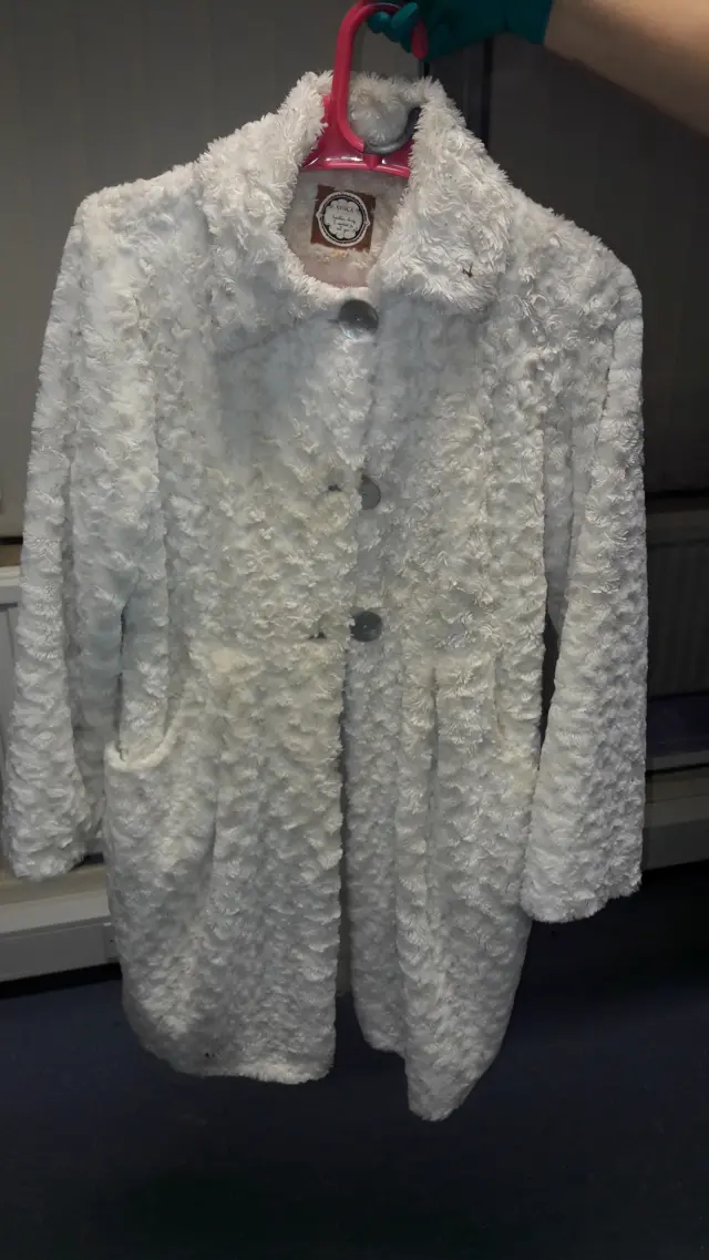 The white/cream faux fur coat