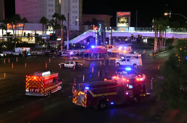 Police and rescue personnel gather at the intersection of Las Vegas Boulevard and Tropicana Ave