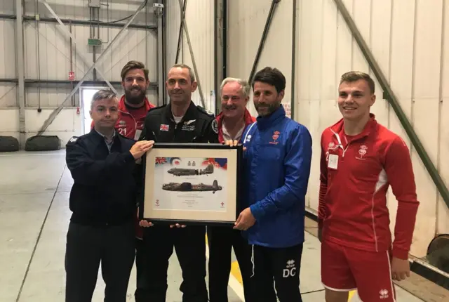 Danny Cowley and co pose around a picture of a Lancaster Bomber with the BBMF