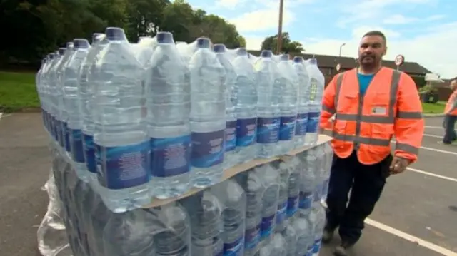 Bottled water being handed out