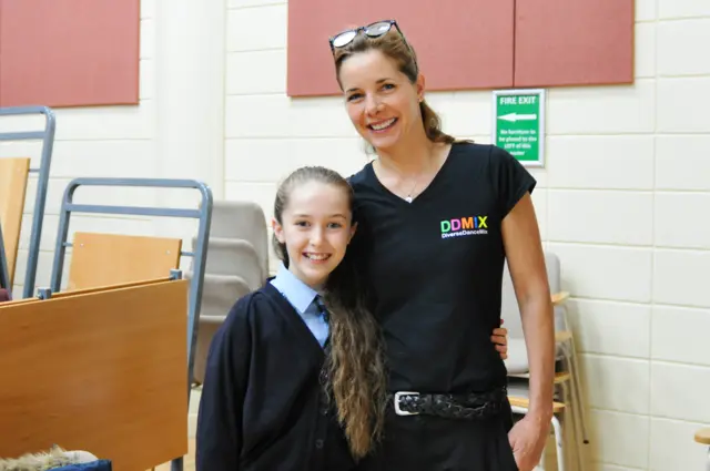 Darcy poses with a student