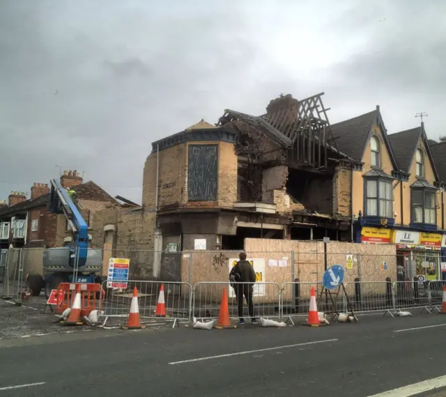 The building in the process of being demolished.