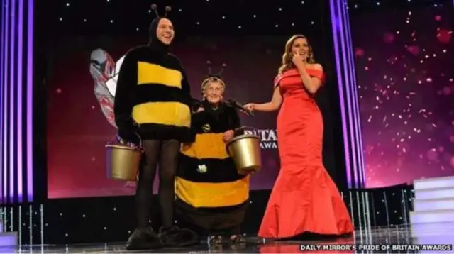 Jean Bishop otherwise known as the Bee Lady with David Walliams, both dressed in bee costumes.