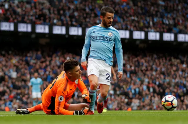 Nick Pope fouls Manchester City's Bernardo Silva