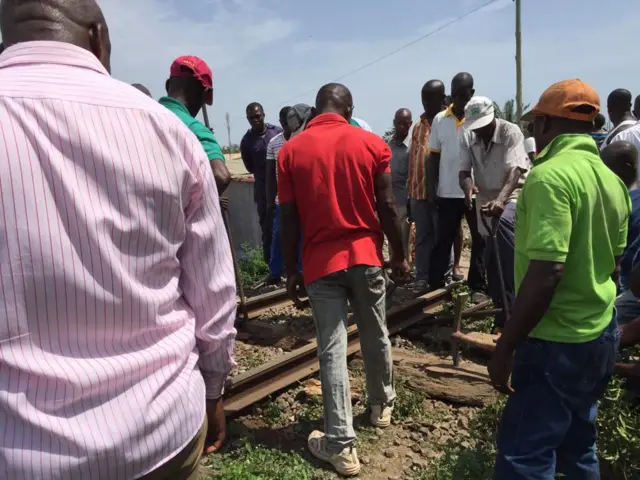 People inspect railway tracks