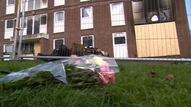 Flowers left outside the council-owned flats in Stoke-on-Trent