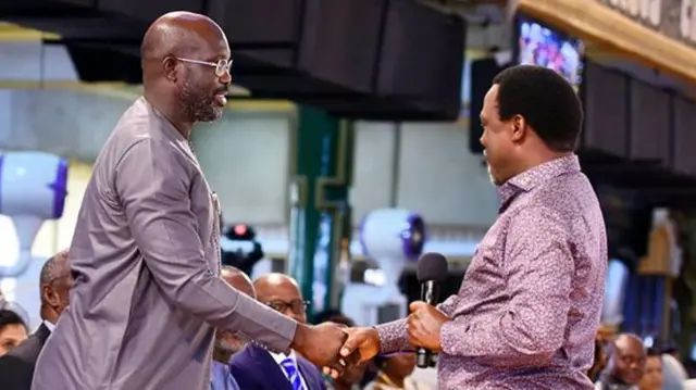 Pastor TB Joshua and George Weah shake hands in the church