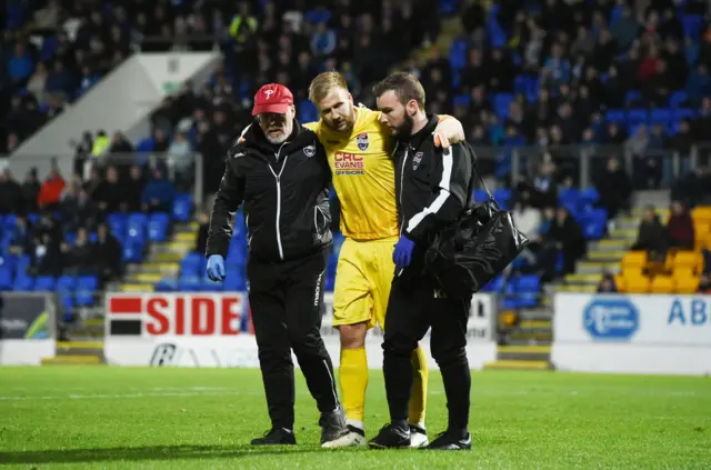 Ross County goalkeeper Scott Fox is helped off