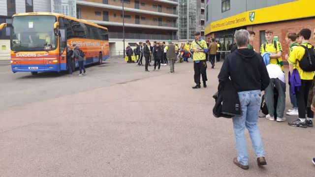 City fans and coaches at Carrow Road