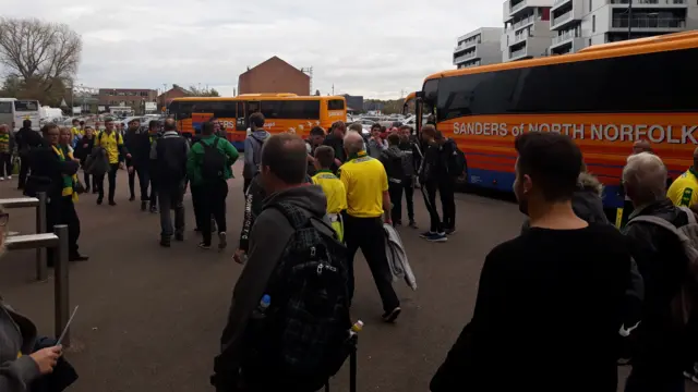 City fans and coaches at Carrow Road