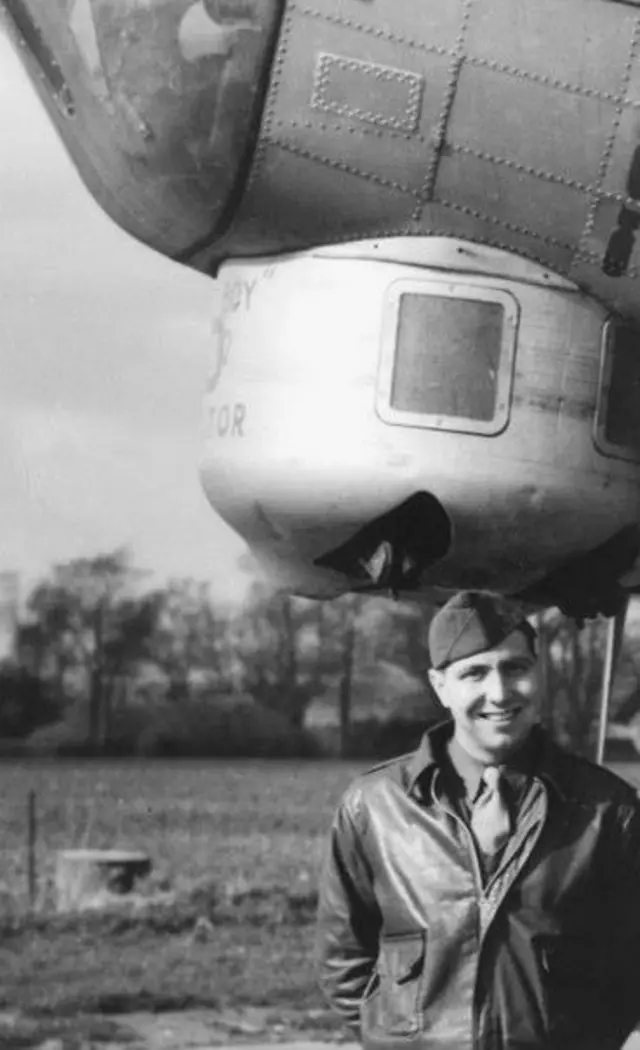 Black and white photo of Ray Fredette by a bomber