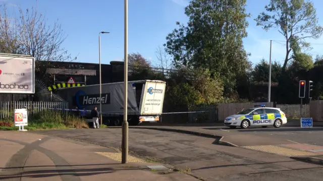 Lorry stuck under low bridge