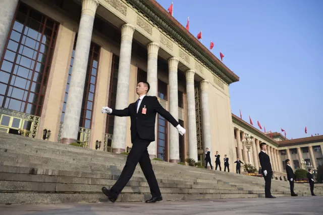 A group of security guards prepare for the closing of the 19th Communist Party Congress outside the Great Hall of the People in Beijing on October 24, 2017.