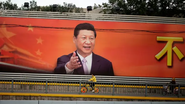 A poster with a portrait of Chinese President Xi Jinping is displayed along a street in Shanghai, China, October 24, 2017.