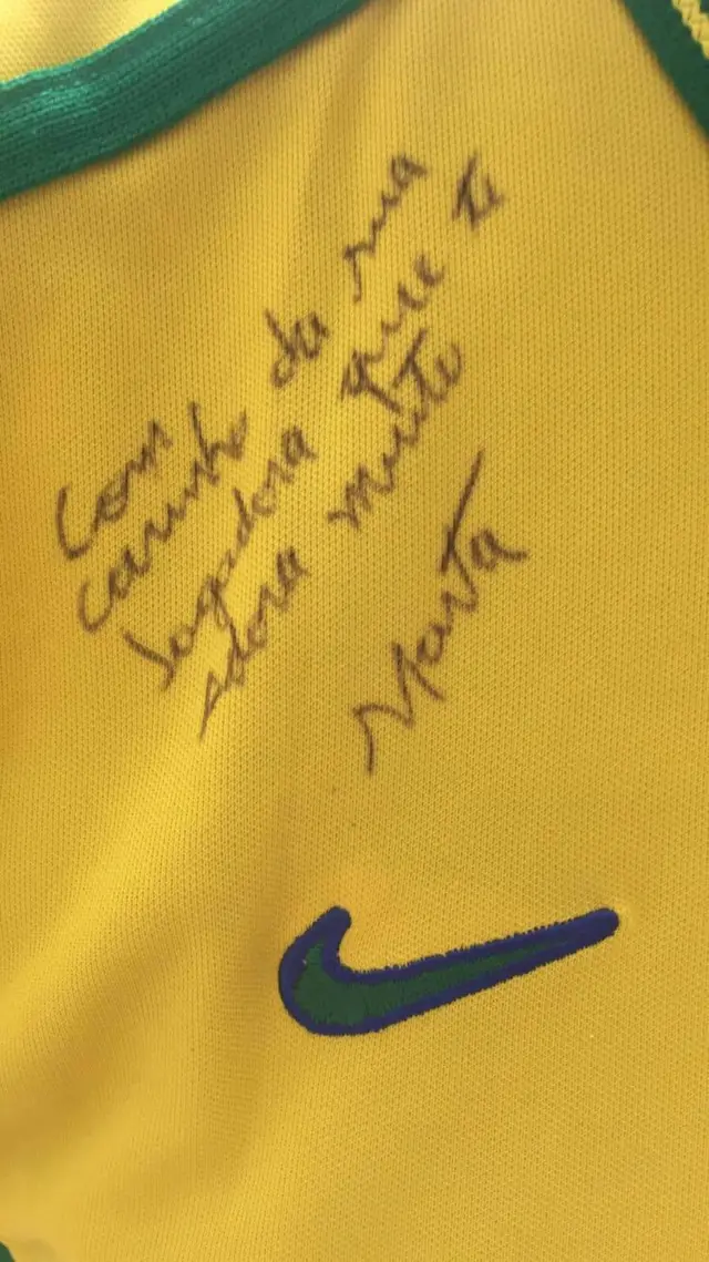 A close-up of a message written on a Brazil football shirt from Marta