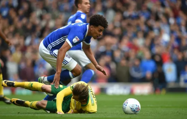 Tom Adeyemi battles for the ball, with Norwich City's James Maddison