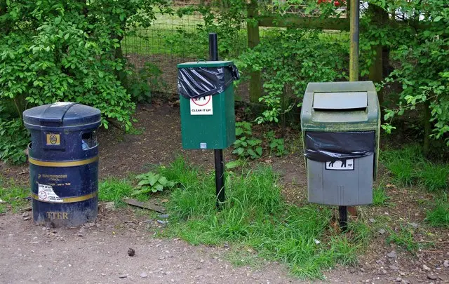 A litter bin and two dog waste bins