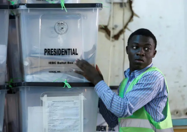 An Independent Electoral and Boundaries Commission (IEBC) official stacks ballot boxes at a tally centre in Nairobi, Kenya October 27, 2017.