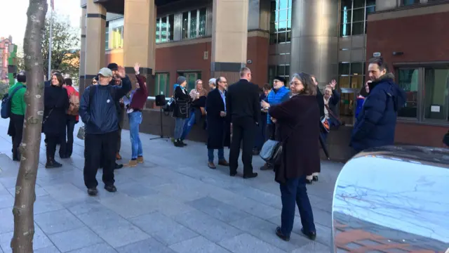 Protesters gather outside court